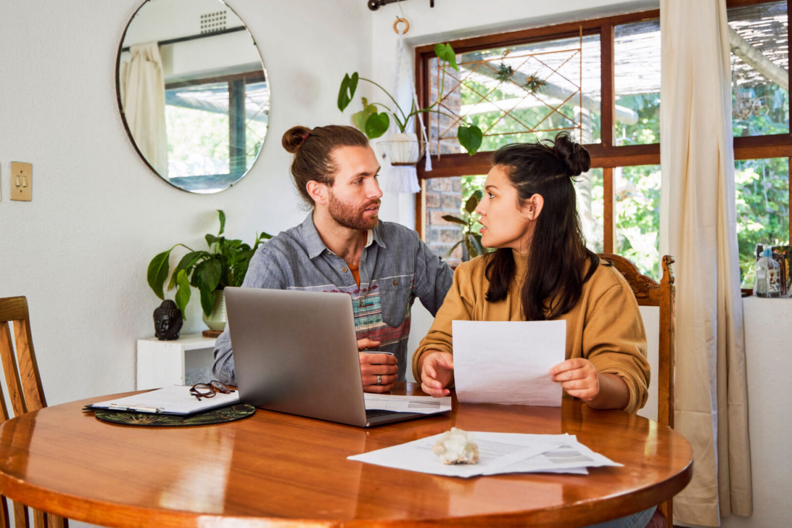Man and woman with laptop and papers
