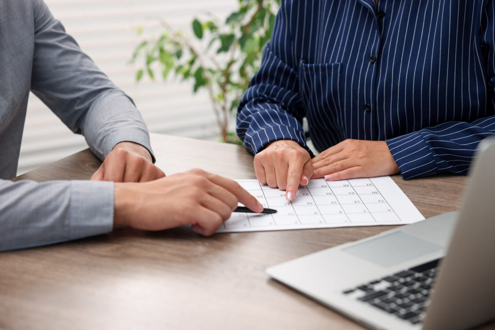 Two people discussing a calendar.
