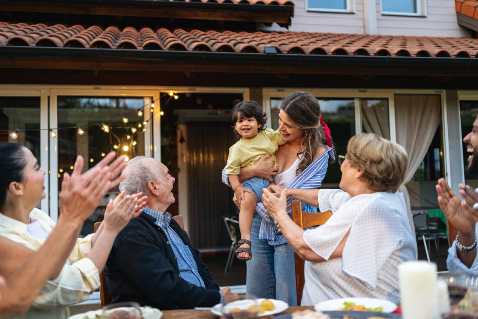 Family gathering with child and applause