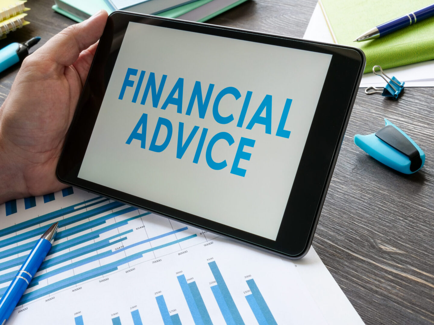 Hand holding tablet with financial advice