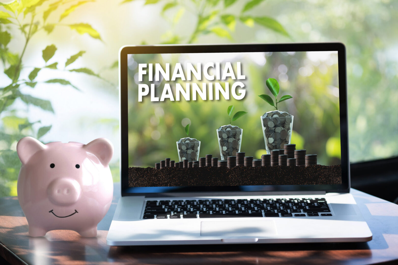 Piggy bank and financial planning laptop