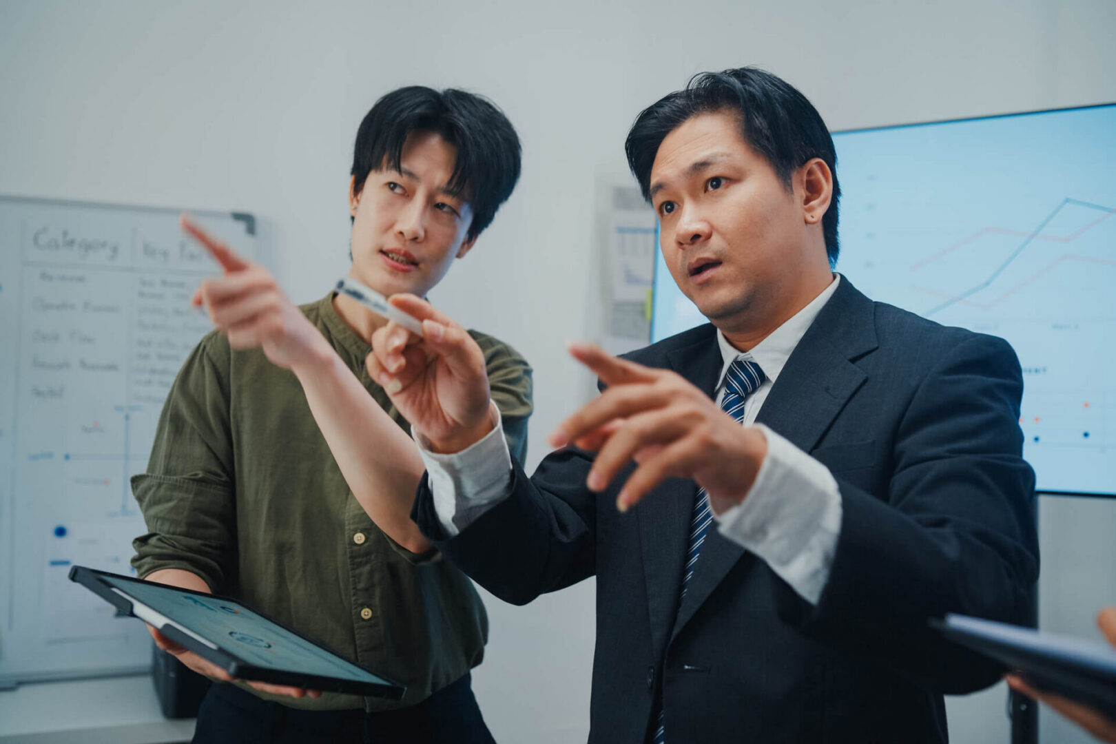 Two business professionals pointing at presentation